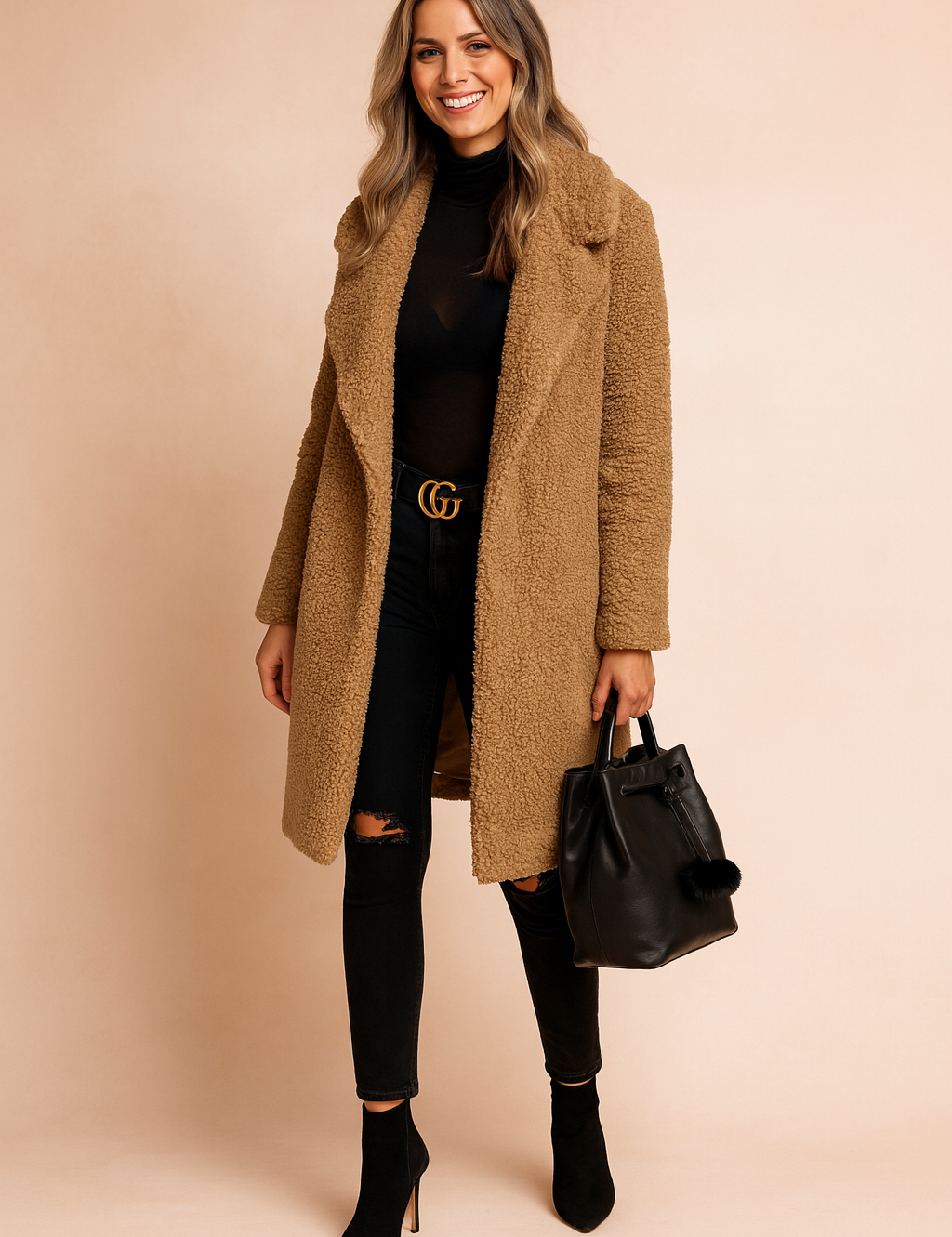  Camel teddy coat with a notched collar, worn over a black turtleneck top and paired with distressed black skinny jeans, a black leather belt with gold buckle, black pointed-toe ankle boots, and a black leather handbag with pom-pom detail.