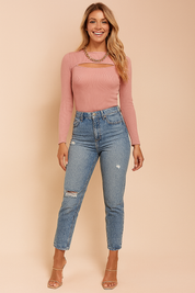 Ribbed dusty rose long-sleeve top with cut-out neckline detail, paired with high-waisted distressed blue jeans and a chunky gold chain necklace.