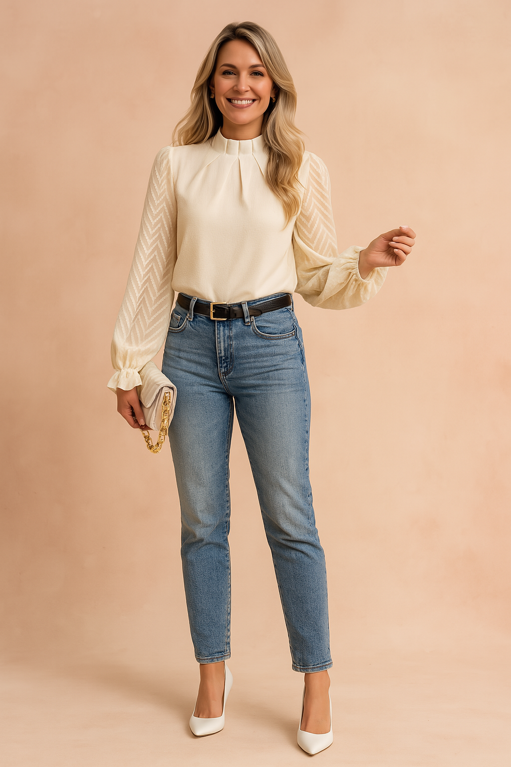 Elegant long-sleeve cream blouse with pleated neckline and sheer chevron-patterned sleeves, paired with high-waisted blue jeans and a black belt.