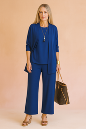Elegant cobalt blue three-piece women’s outfit featuring an open-front cardigan, matching loose-fit tunic, and wide-leg trousers in soft stretch fabric.