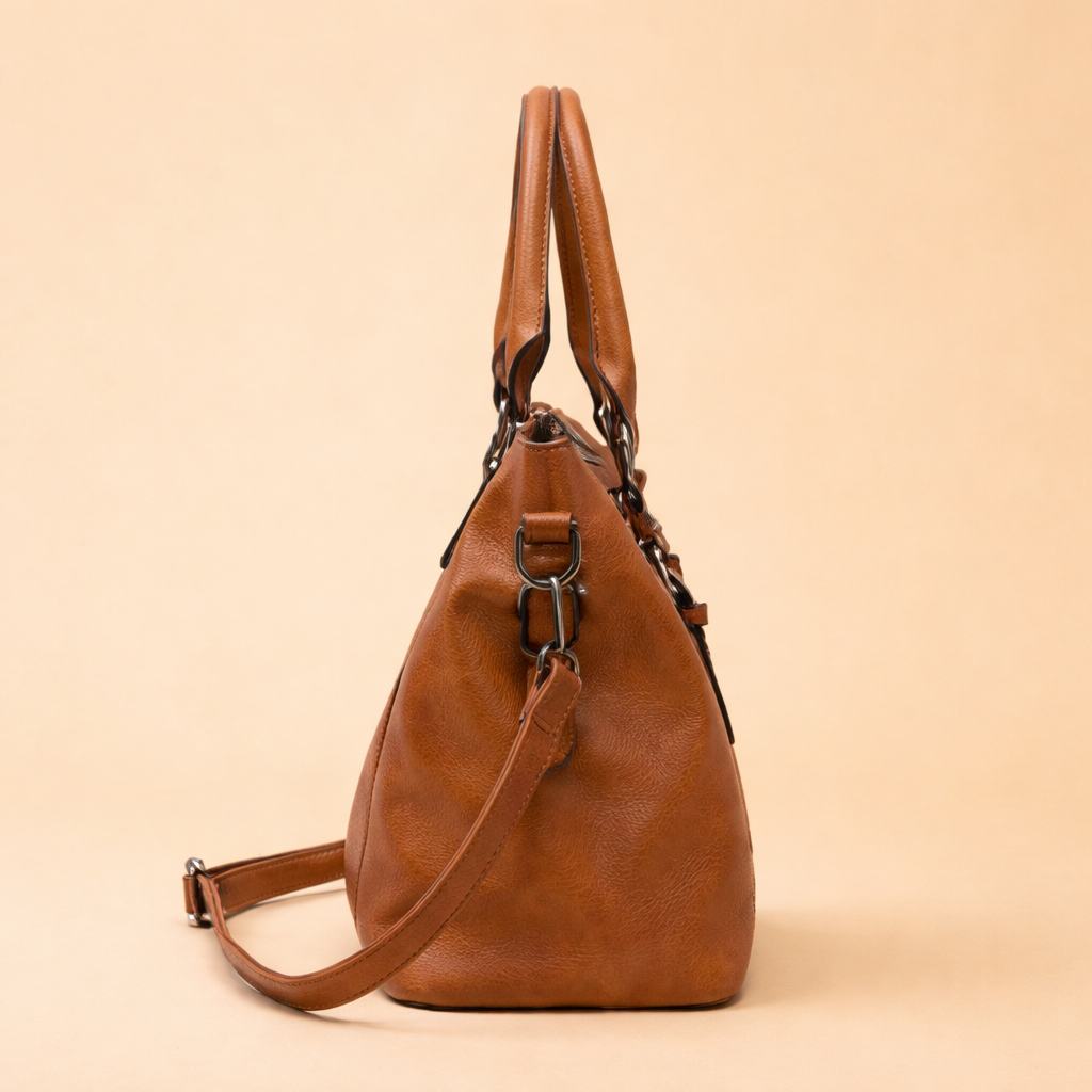 Structured cognac brown leather handbag with dual top handles, adjustable shoulder strap, and refined metal hardware for a timeless everyday carry.