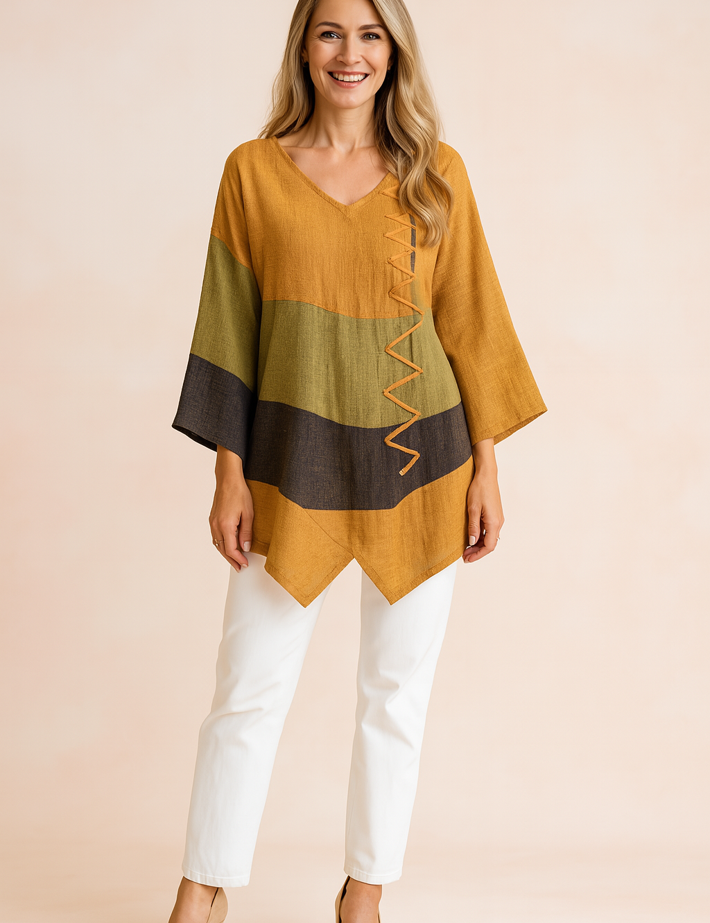 Loose-fit V-neck tunic with mustard, olive green, and charcoal color blocking, featuring asymmetrical hemline and decorative zigzag stitching on the front.