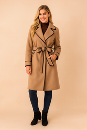 Chic belted trench coat with contrast black trim detailing, tailored lapels, and a modern waist tie for a polished silhouette.