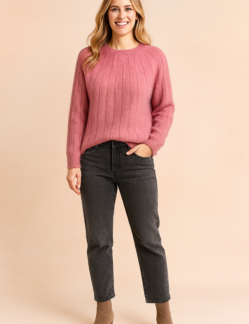 Dusty pink ribbed knit fuzzy sweater paired with high-waisted dark gray jeans and taupe suede ankle boots.
