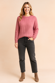 Dusty pink ribbed knit fuzzy sweater paired with high-waisted dark gray jeans and taupe suede ankle boots.