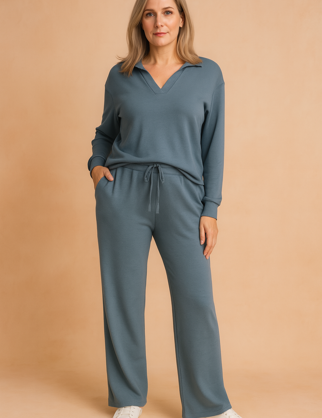 Dusty blue long-sleeve loungewear set featuring a V-neck top and matching wide-leg drawstring pants, made from soft knit fabric.