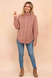 Oversized dusty rose cable knit turtleneck sweater paired with light blue distressed skinny jeans, taupe ankle boots, and silver bangles.