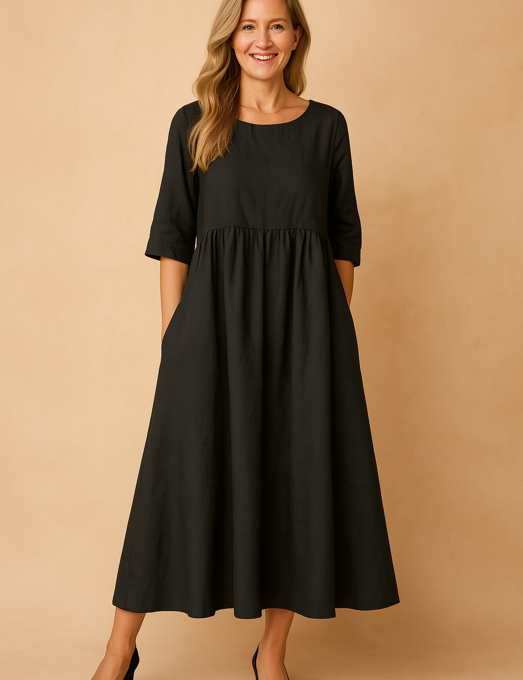 Black linen A-line maxi dress with elbow-length sleeves, a gathered high waist, discreet side pockets, and a wide flowing hem.