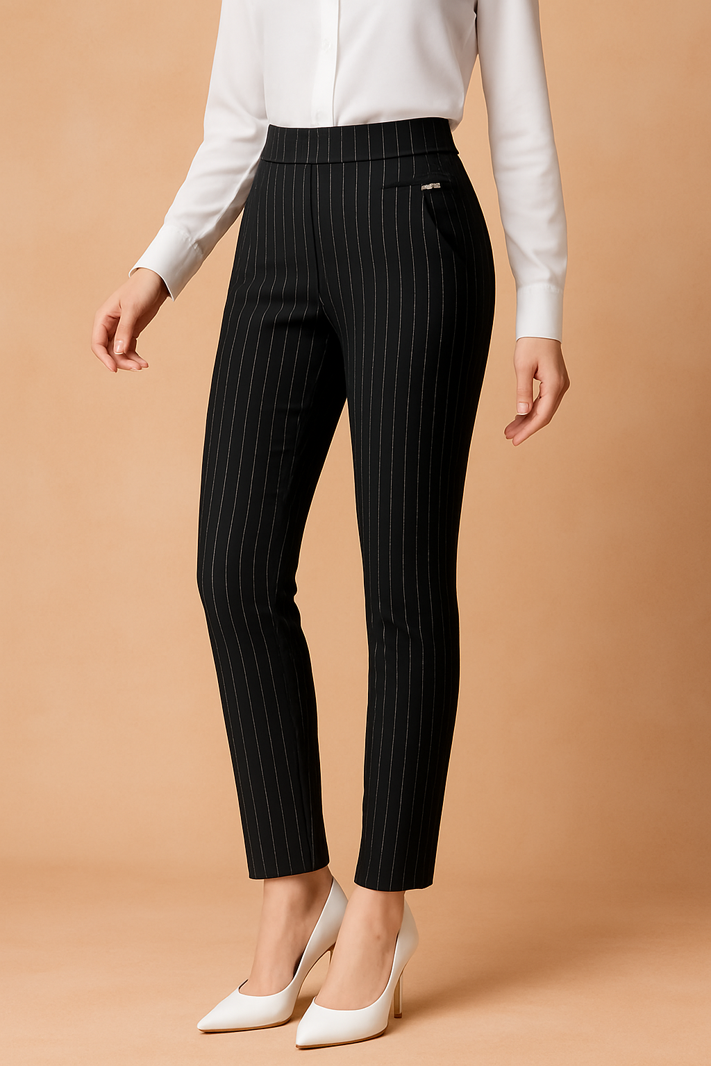 High-waisted black pinstripe slim-fit pants with vertical white stitching and a decorative front pocket tab, styled with a crisp white blouse and pointed white heels for a polished, professional look.