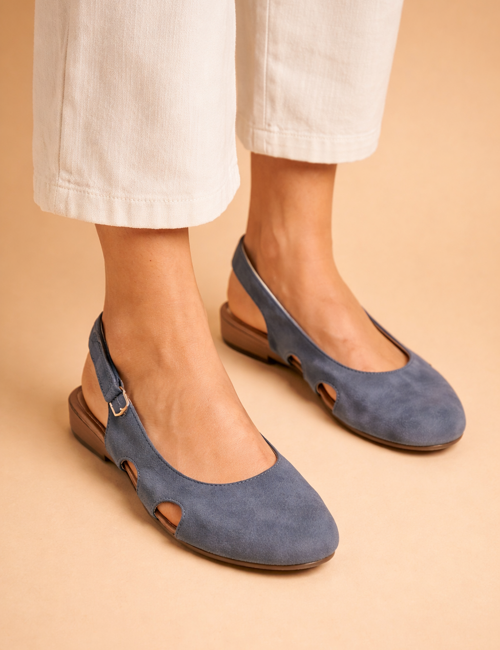 elegant-female-model-wearing-blue-suede-slingback-flats-studio-fashion-shot.png