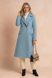  Elegant light blue double-breasted wool coat with gold buttons, notched collar, and flap pockets, paired with a white turtleneck, beige tailored trousers, and black suede ankle boots, accessorized with a patterned chain-strap handbag.
