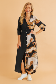 Baroque print and black colorblock button-down maxi shirt dress with long sleeves, front slit, and structured collar, styled with white sneakers.