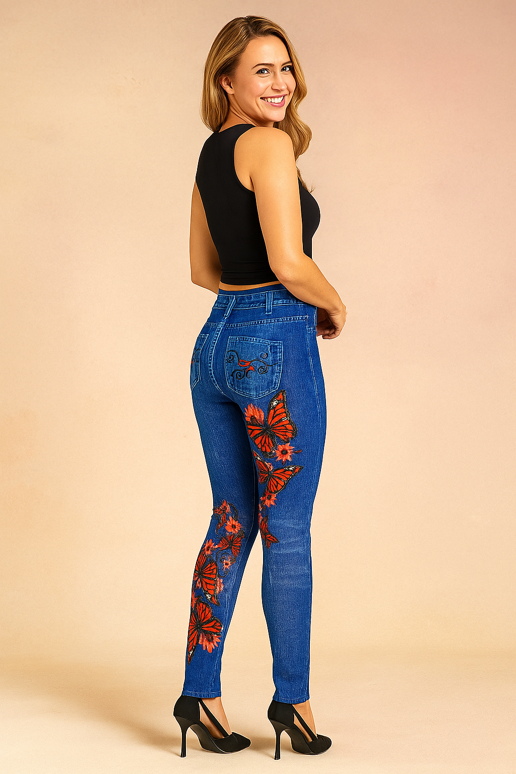High-waisted skinny blue jeans with vibrant red butterfly and floral embroidery, detailed pocket stitching, and a slim tailored fit.