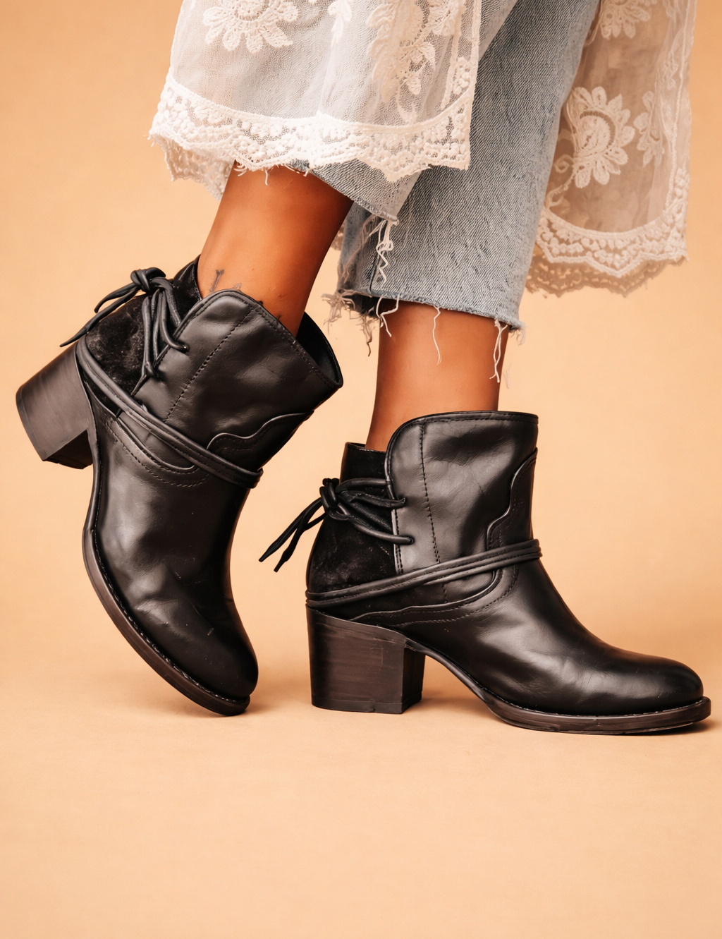 european-model-black-leather-ankle-boots-lace-denim-studio-sand-background-editorial-shot.png