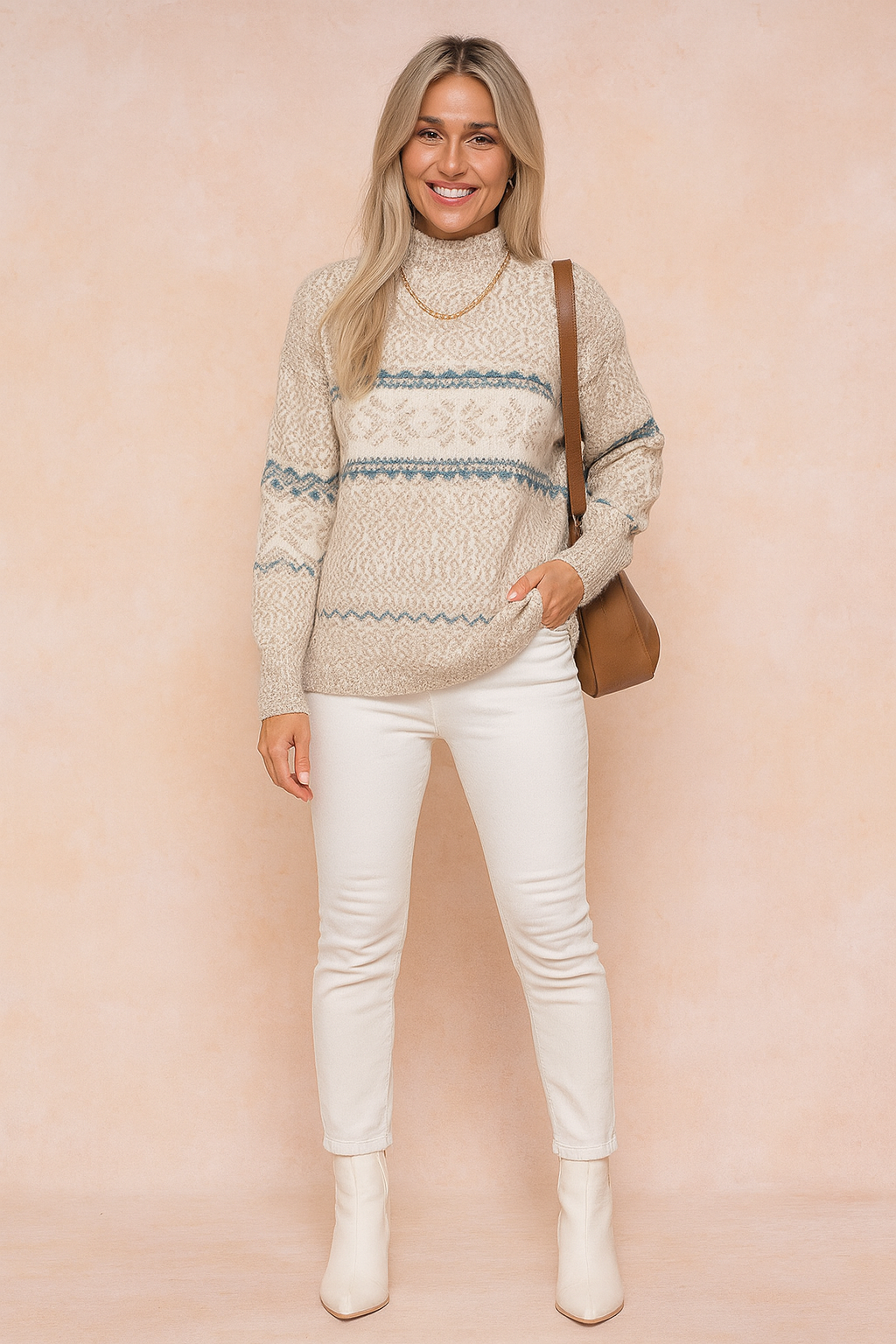Cozy beige and white Fair Isle knit sweater with blue accents, paired with slim white jeans and cream ankle boots, accessorized with a brown leather shoulder bag.