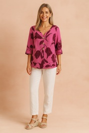 Women's fuchsia blouse with dark burgundy tulip floral print, V-neckline, three wooden buttons, 3/4 sleeves, and a relaxed fit.