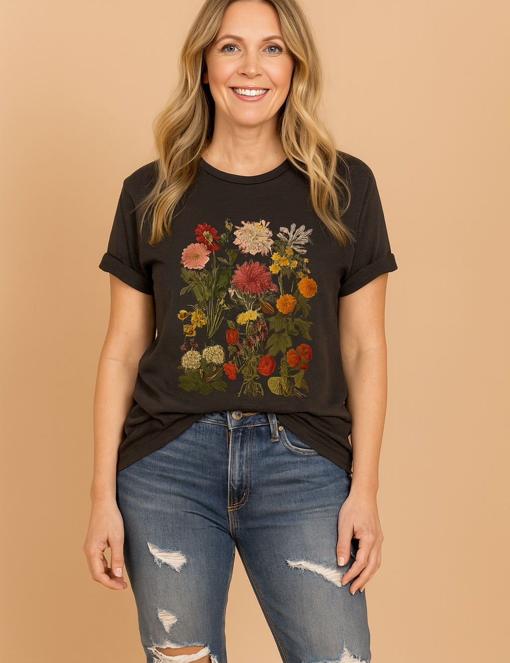 Women's charcoal graphic T-shirt with vivid multicolor botanical floral print, styled with distressed denim jeans.