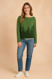 Forest green fuzzy knit sweater with dark green evergreen tree silhouette design, paired with mid-rise straight-leg blue jeans and white low-top sneakers.