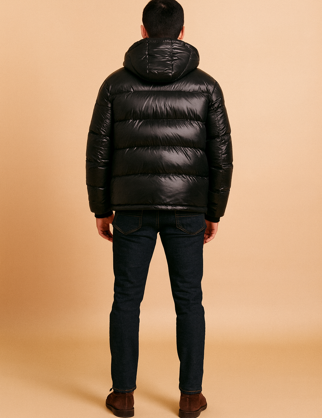 Back view of a glossy black puffer jacket with hood, horizontal quilted padding, and casual modern fit.