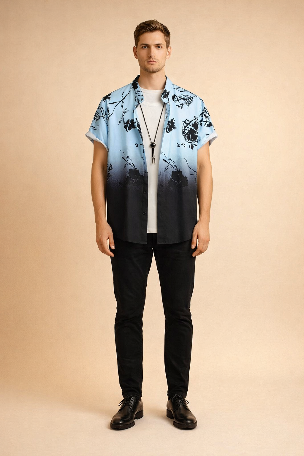 Short-sleeve button-up shirt with a light blue to deep black gradient, featuring a bold black floral print with crisp outlines and consistent color saturation, styled open over a clean white crew-neck T-shirt and finished with a minimal black cord pendant necklace.