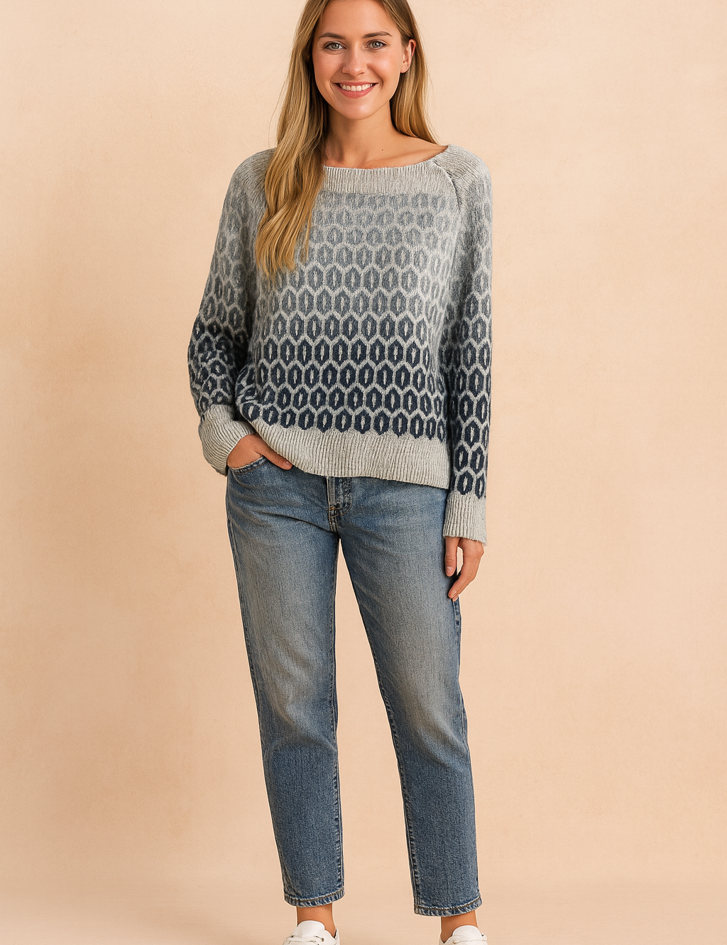 Grey to navy gradient knit sweater with oval geometric pattern, paired with mid-wash straight-leg jeans and white lace-up sneakers.