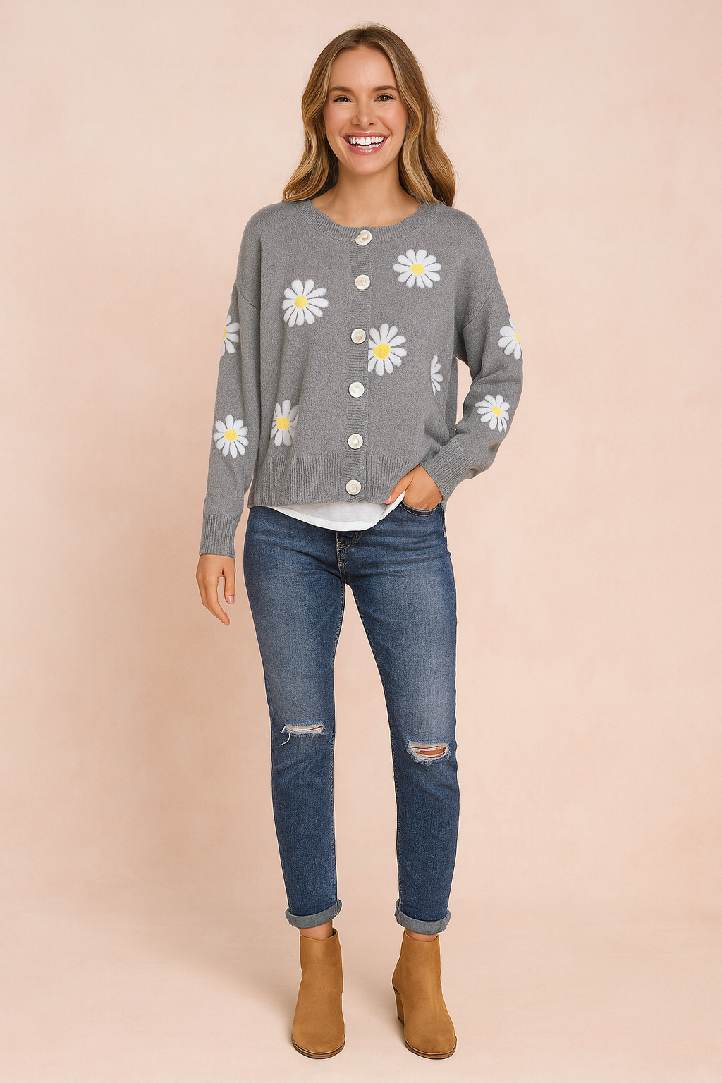 Gray button-up cardigan with white daisy prints and ribbed cuffs and hem, layered over a white top, paired with medium-wash distressed jeans and tan ankle boots.