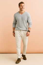 Light gray textured knit sweater paired with off-white drawstring pants and brown suede lace-up shoes.