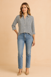 Classic striped button-up blouse with vertical navy and white lines, designed with a relaxed fit and front pocket, paired with high-waisted light wash denim jeans and navy ballet flats for a polished casual look.