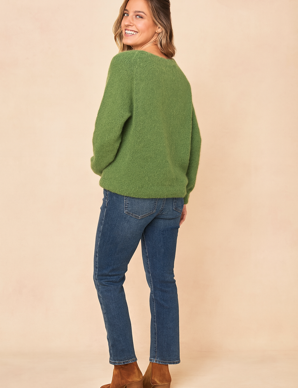 Soft green fuzzy knit sweater with a relaxed fit, paired with medium-wash straight-leg jeans and brown suede heeled ankle boots.