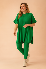 Two-piece green ribbed knit loungewear set featuring a loose-fit short-sleeve tunic top with side slits and matching high-waisted ankle-length leggings.