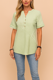Light mint green short-sleeve cotton blouse with mixed ribbed and striped texture, featuring a mandarin collar, five-button placket, and relaxed fit, paired with slim-fit light blue jeans for a casual yet stylish summer outfit.