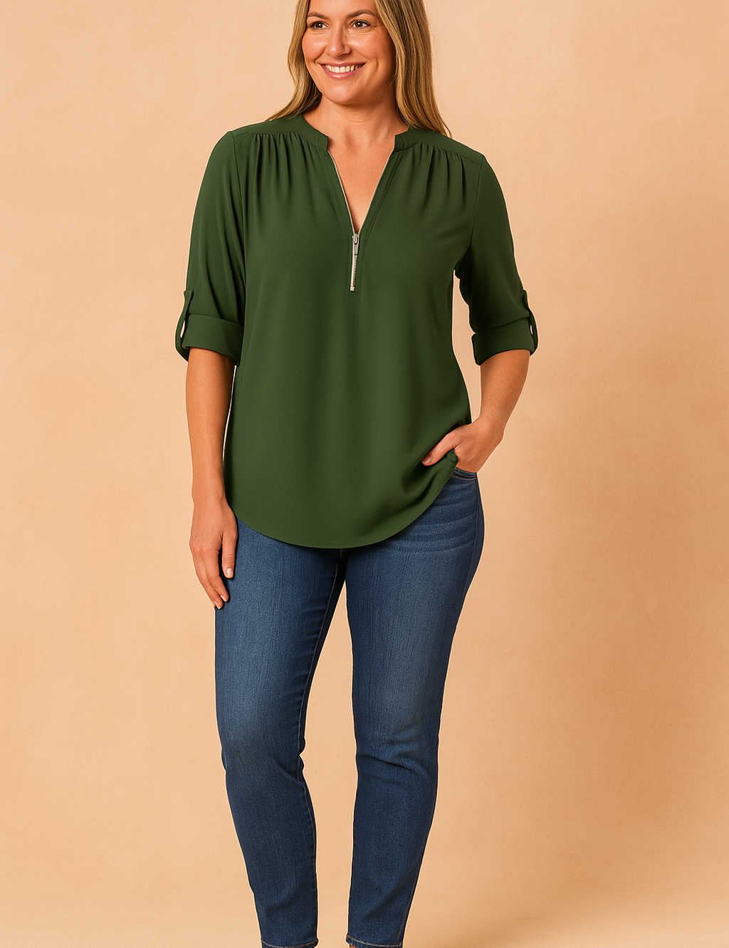 Deep green zip-front blouse with roll-tab sleeves and gentle pleats at the shoulders, paired with classic blue skinny jeans for a clean, everyday look.