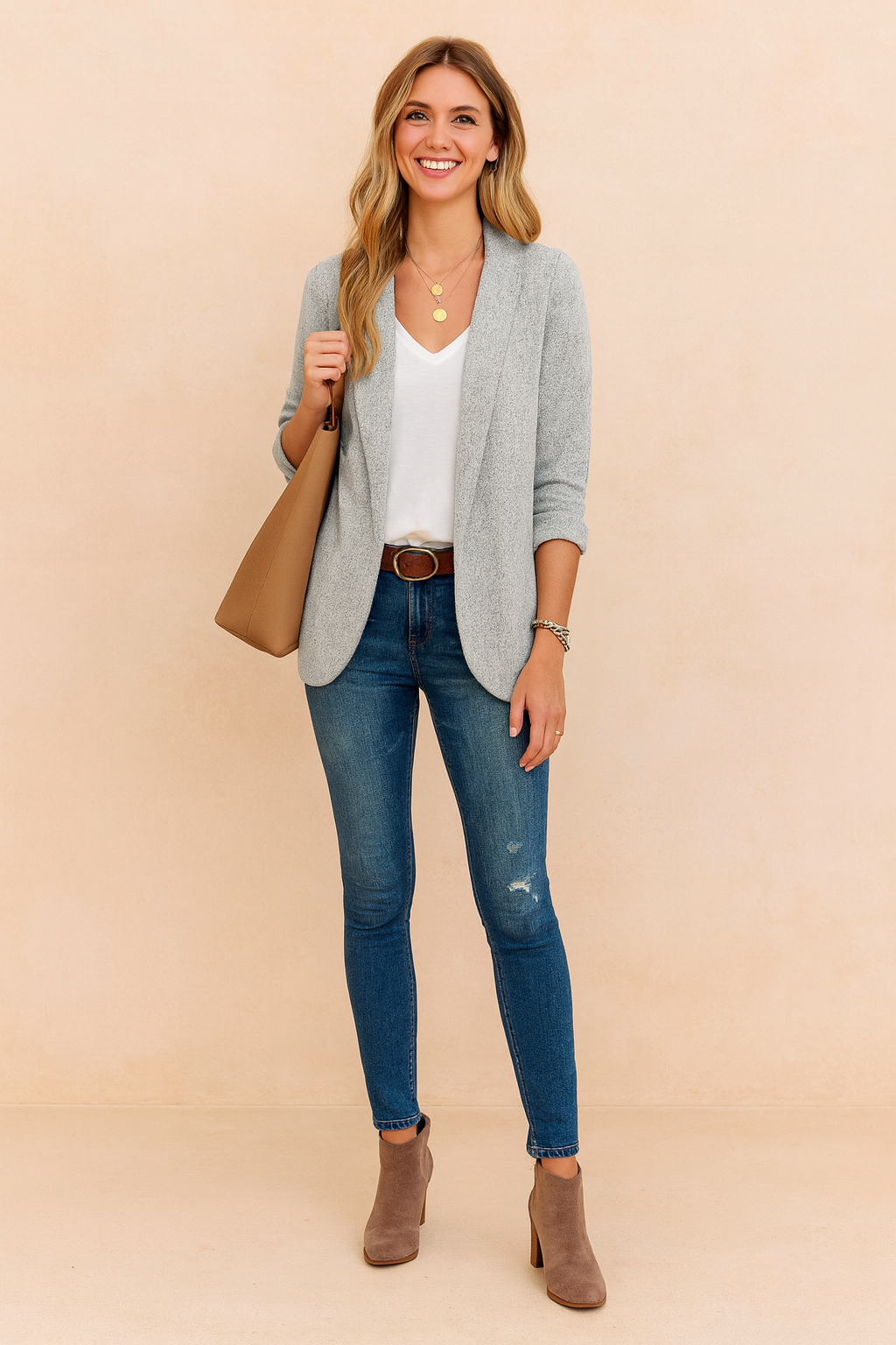 Light grey textured blazer jacket with rolled sleeves, paired with a white top and blue slim-fit jeans.