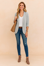 Light grey textured blazer jacket with rolled sleeves, paired with a white top and blue slim-fit jeans.