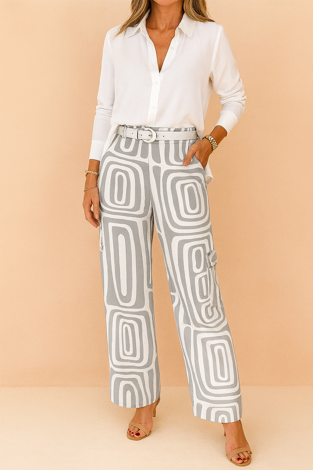 High-waisted straight-leg pants with a modern grey and white geometric print, styled with a matching belt and nude heels.