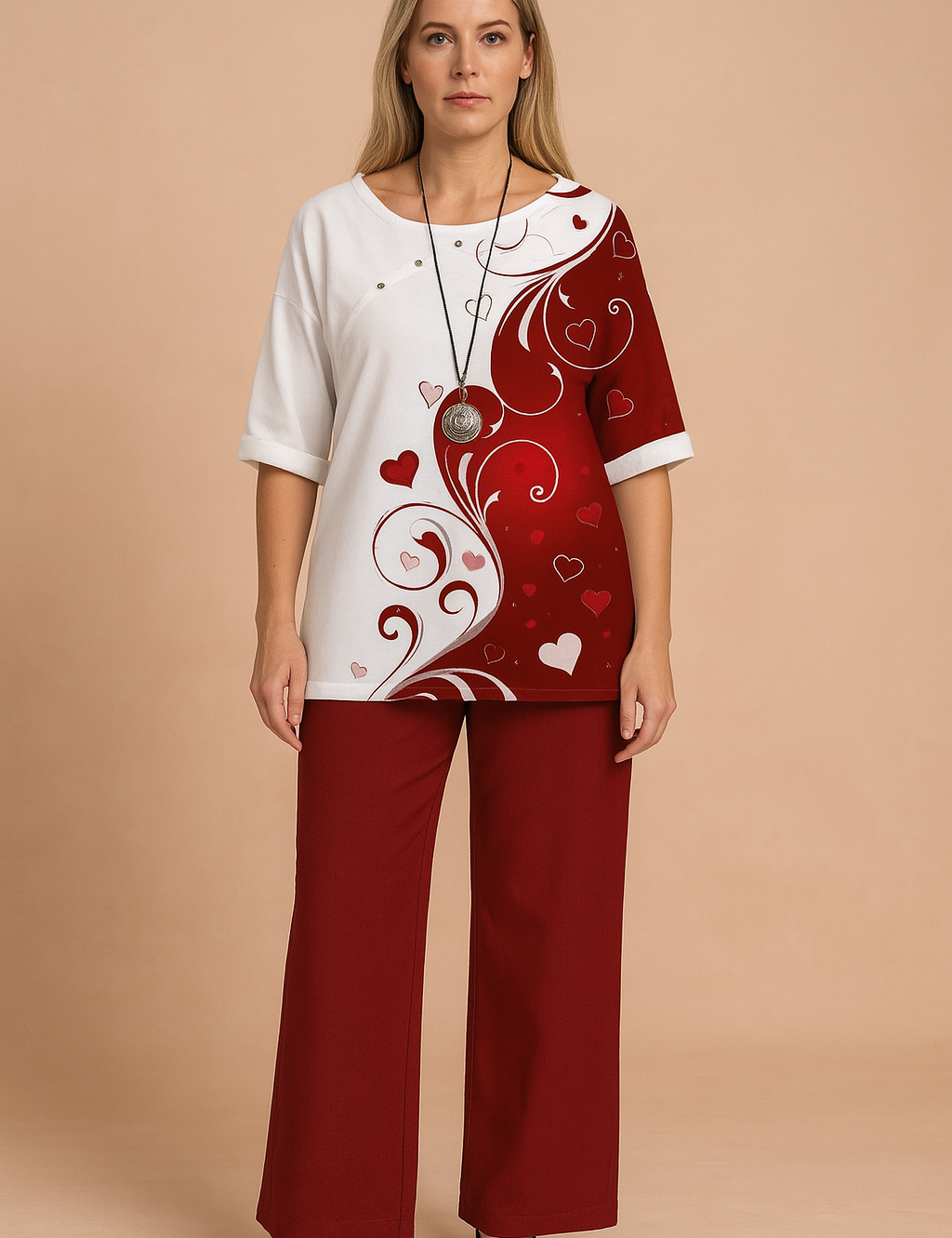 Two-piece set featuring a half-and-half heart swirl print top in white and deep red with short sleeves and side button detail, paired with solid dark red wide-leg trousers in soft cotton-blend fabric.