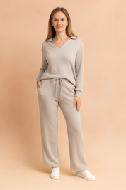 Two-piece heather grey knit loungewear set featuring a long-sleeve collared V-neck top and matching high-waisted wide-leg drawstring pants with a relaxed fit.
