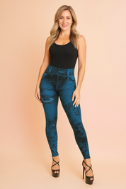 High-waisted blue distressed jeggings with faux pocket detailing, ripped accents, and a slim-fit stretch design styled with black strappy high-heel sandals.