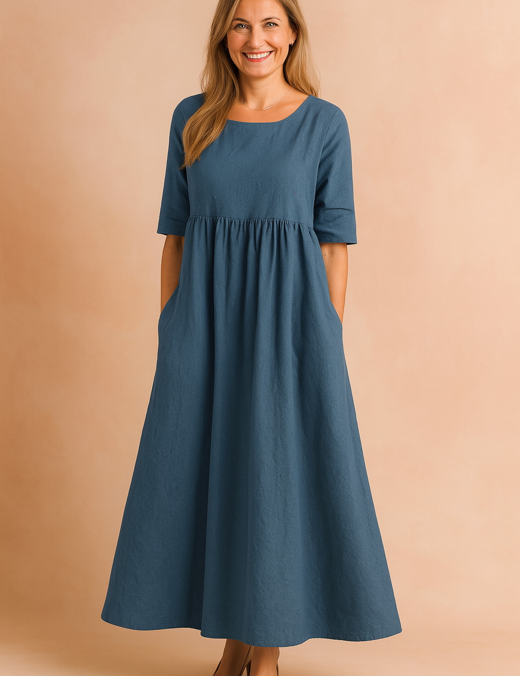 Flowy indigo-blue linen midi dress with half sleeves, a gathered waist, and side pockets in a relaxed A-line silhouette.