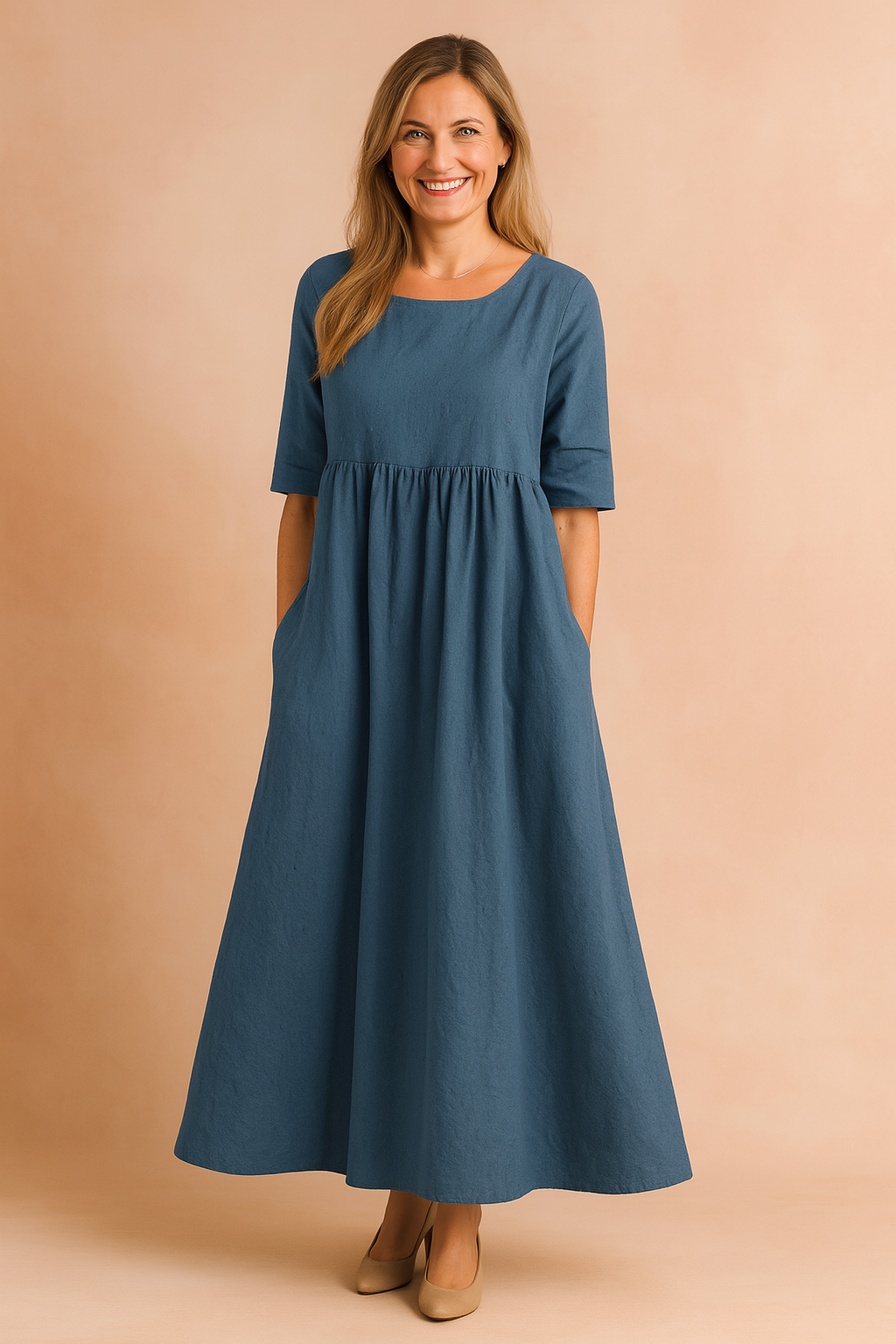 Flowy indigo-blue linen midi dress with half sleeves, a gathered waist, and side pockets in a relaxed A-line silhouette.