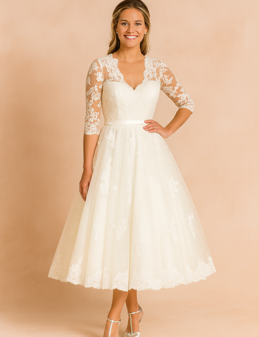 Elegant ivory lace tea-length wedding dress featuring a fitted bodice, sheer three-quarter lace sleeves, a scalloped hemline, and a flared A-line skirt with delicate floral lace detailing.