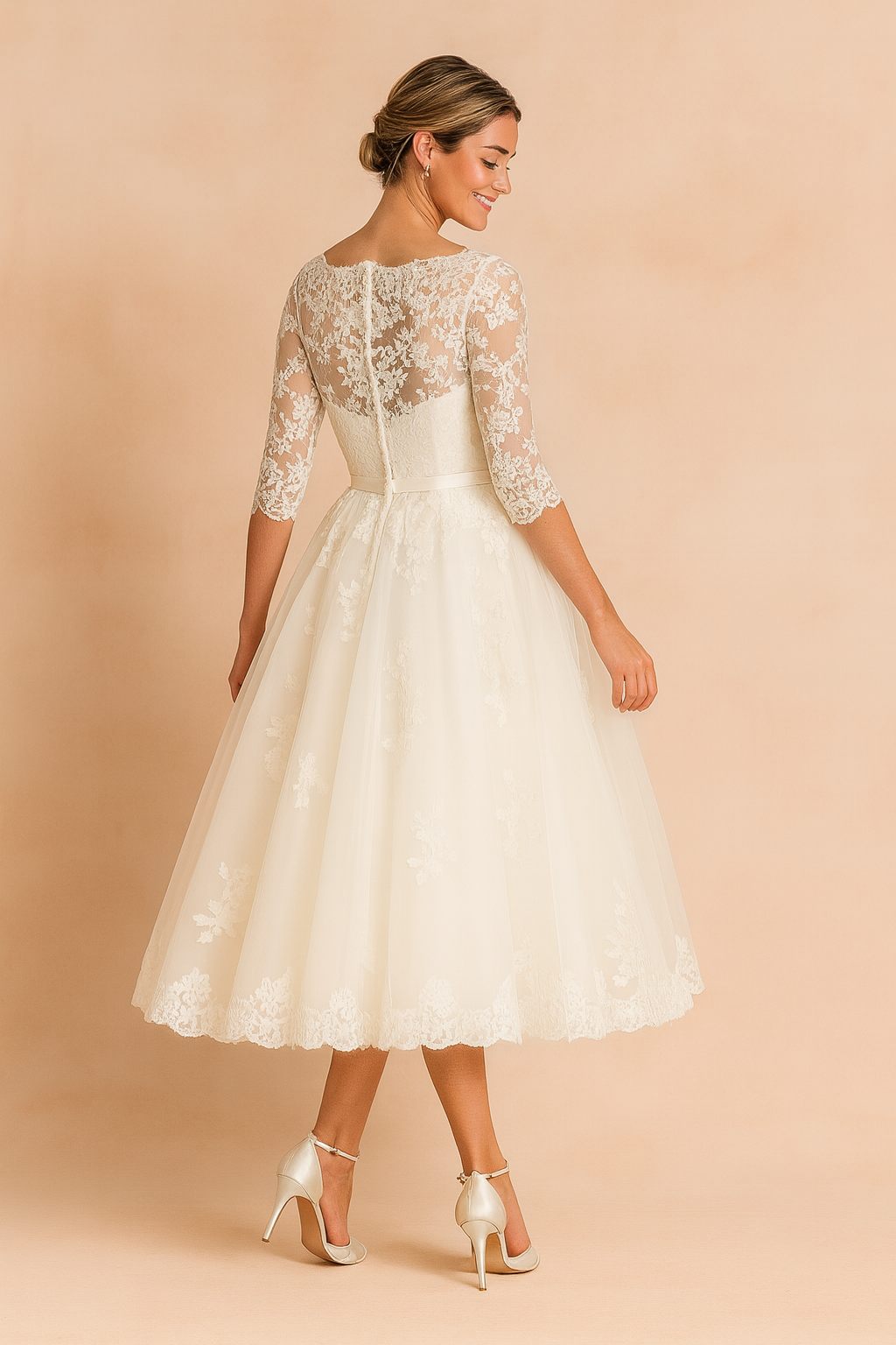 Elegant ivory lace tea-length wedding dress featuring a fitted bodice, sheer three-quarter lace sleeves, a scalloped hemline, and a flared A-line skirt with delicate floral lace detailing.