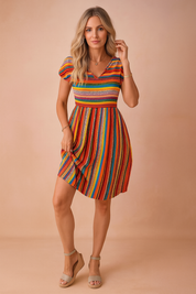 Blonde woman wearing the Josie orange striped short sleeve summer dress.