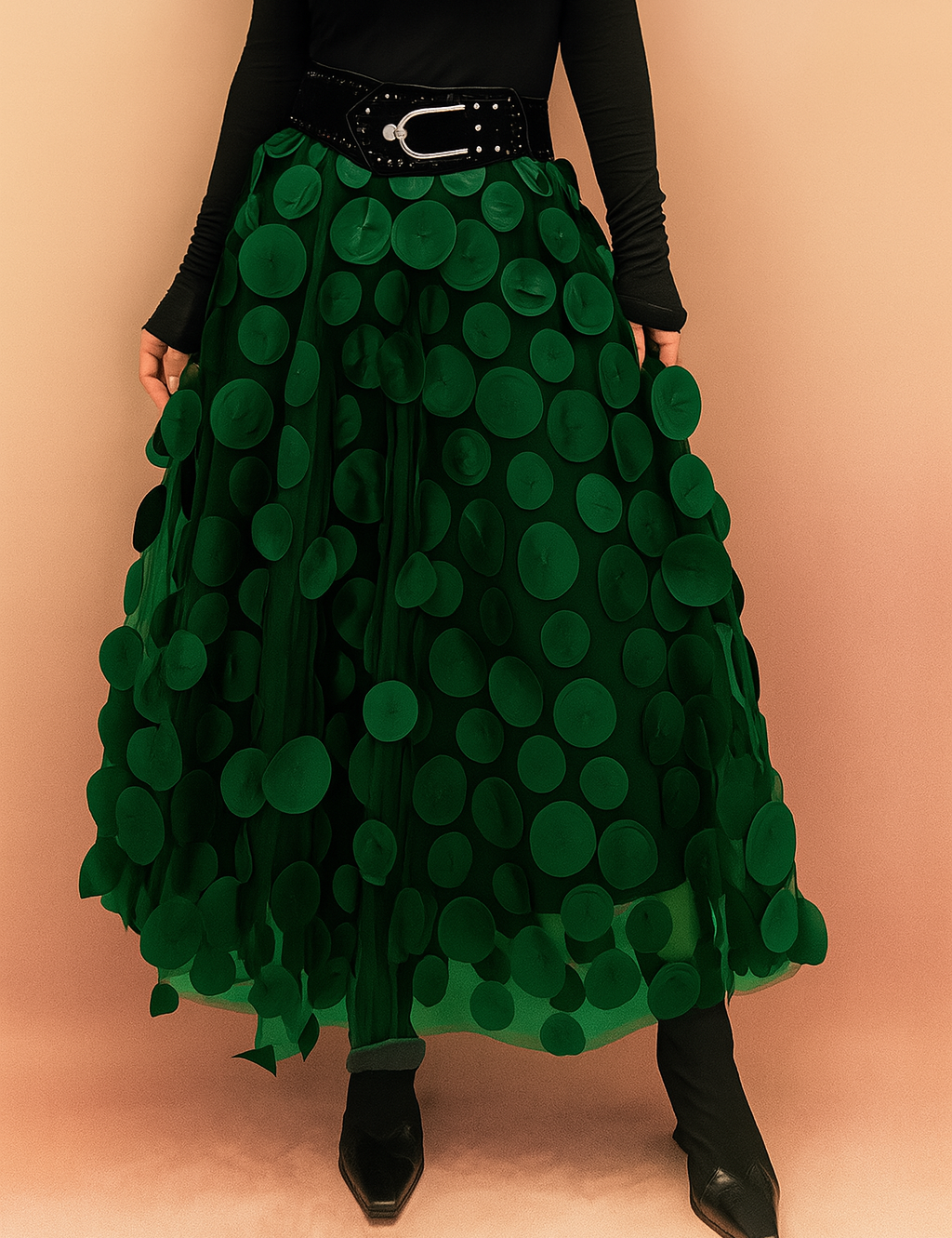 Laura – Elegant dark green summer skirt featuring large circular appliqués, styled with a fitted black top and boots, perfect for bold fashion statements in a chic editorial setting.