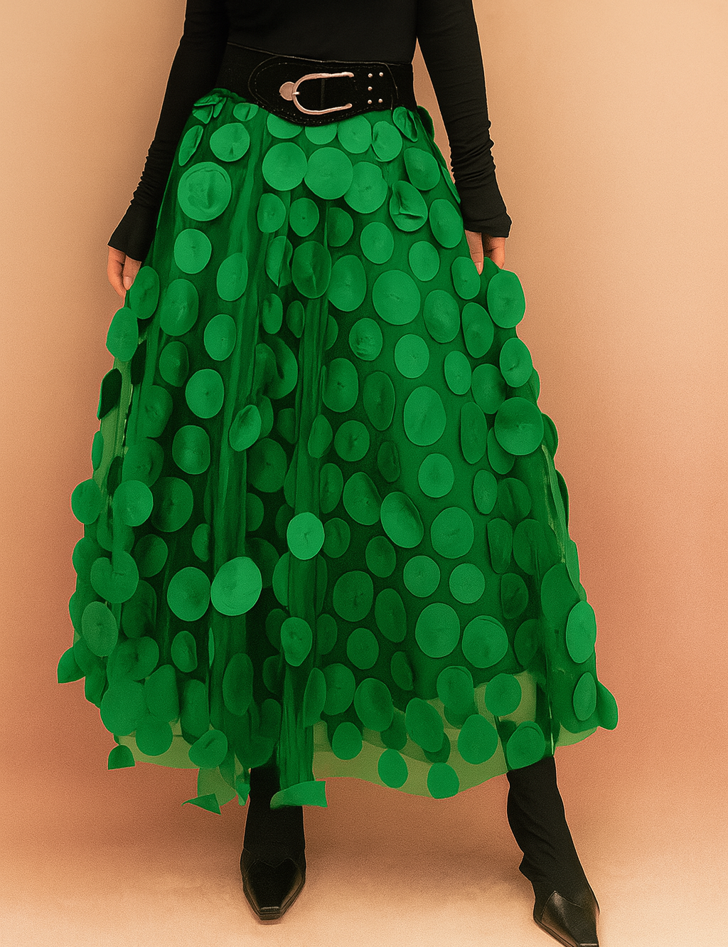 Laura – Elegant light green summer skirt featuring large circular appliqués, styled with a fitted black top and boots, perfect for bold fashion statements in a chic editorial setting.