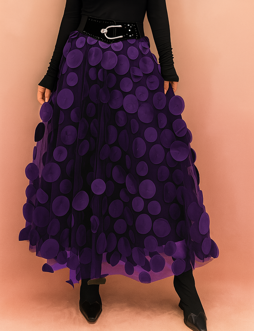 Laura – Elegant violet summer skirt featuring large circular appliqués, styled with a fitted black top and boots, perfect for bold fashion statements in a chic editorial setting.