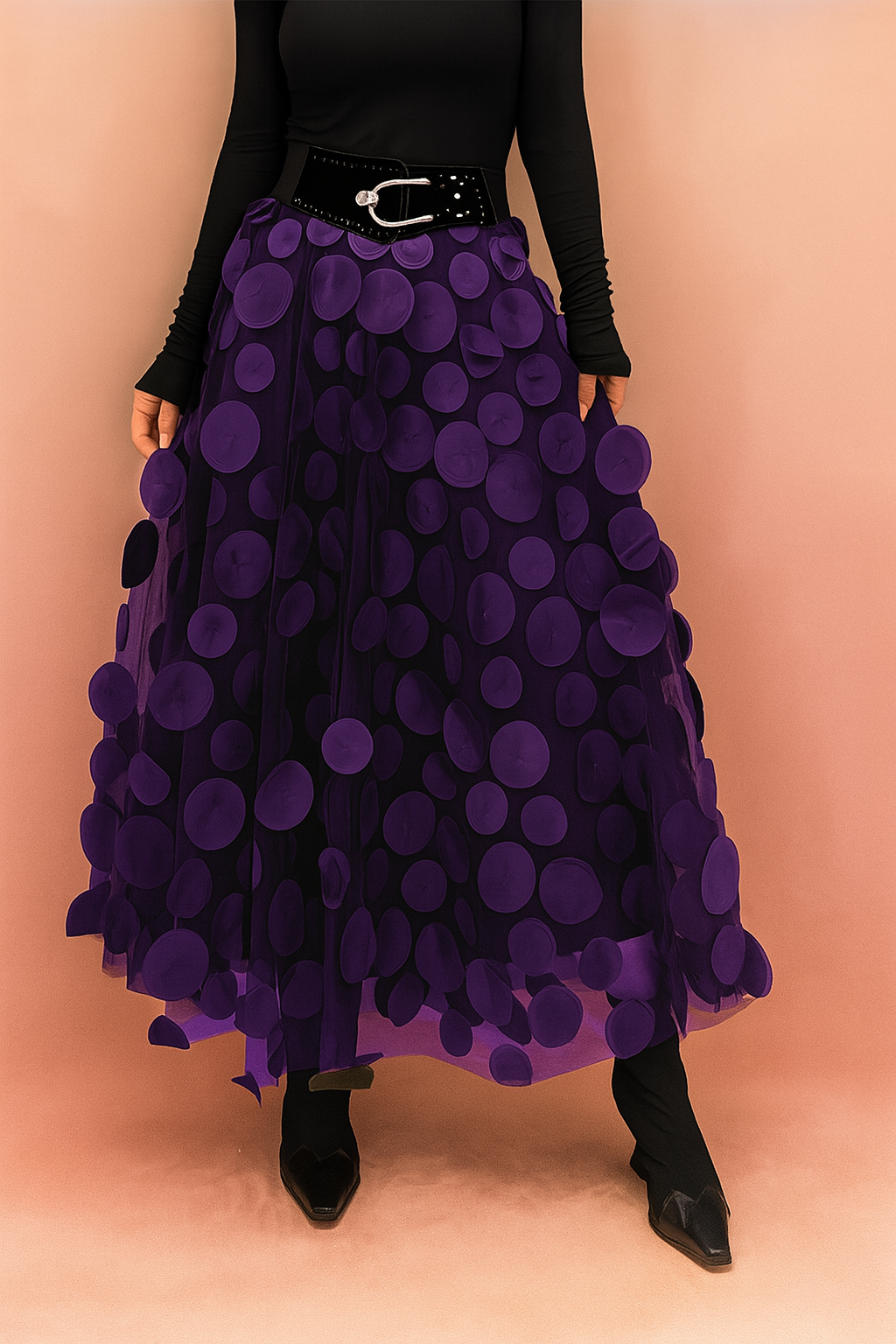 Laura – Elegant violet summer skirt featuring large circular appliqués, styled with a fitted black top and boots, perfect for bold fashion statements in a chic editorial setting.