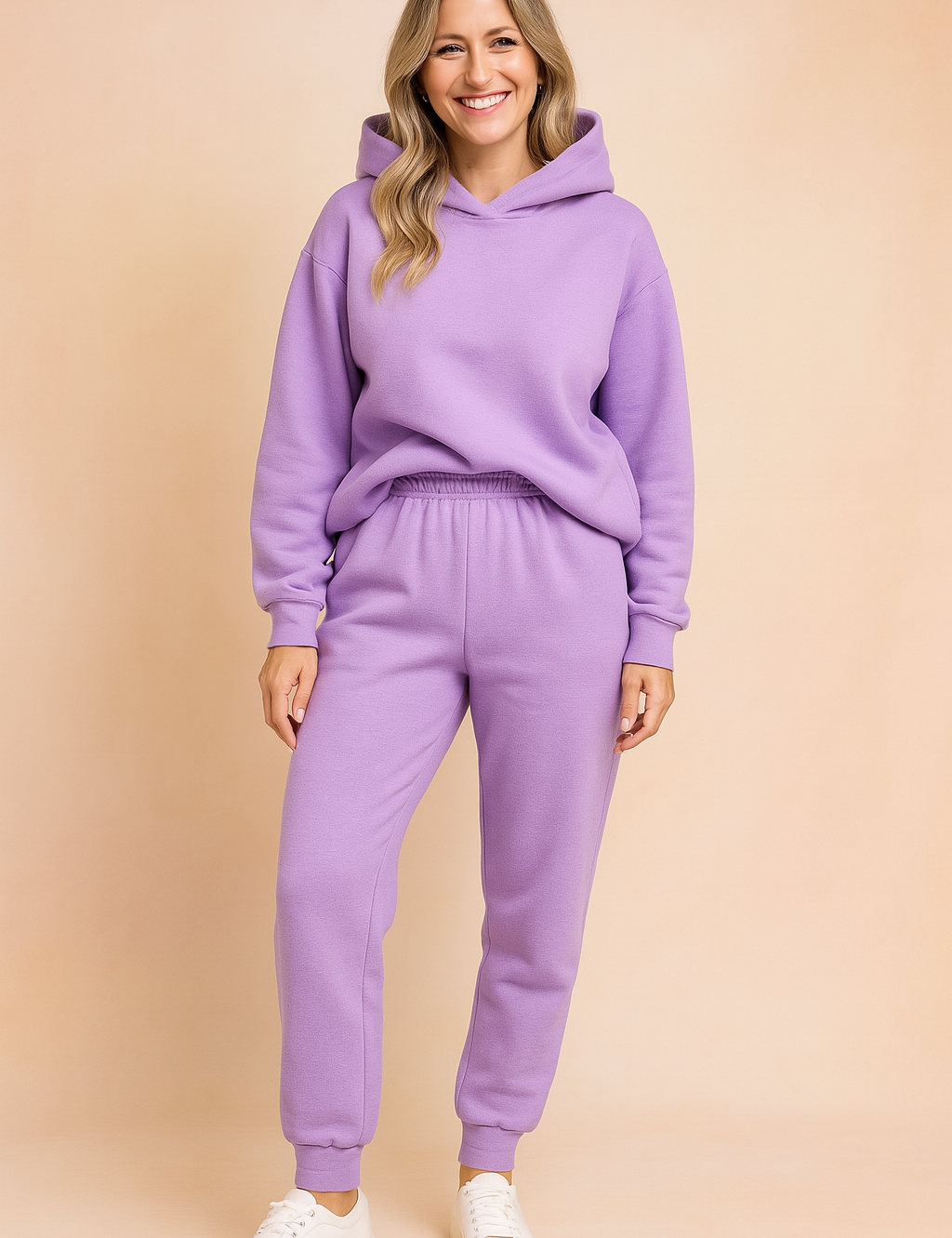 Lavender fleece loungewear set consisting of a cozy hooded sweatshirt with a slightly oversized fit and elastic-waist jogger pants, paired with minimalist white sneakers for a soft casual look.

