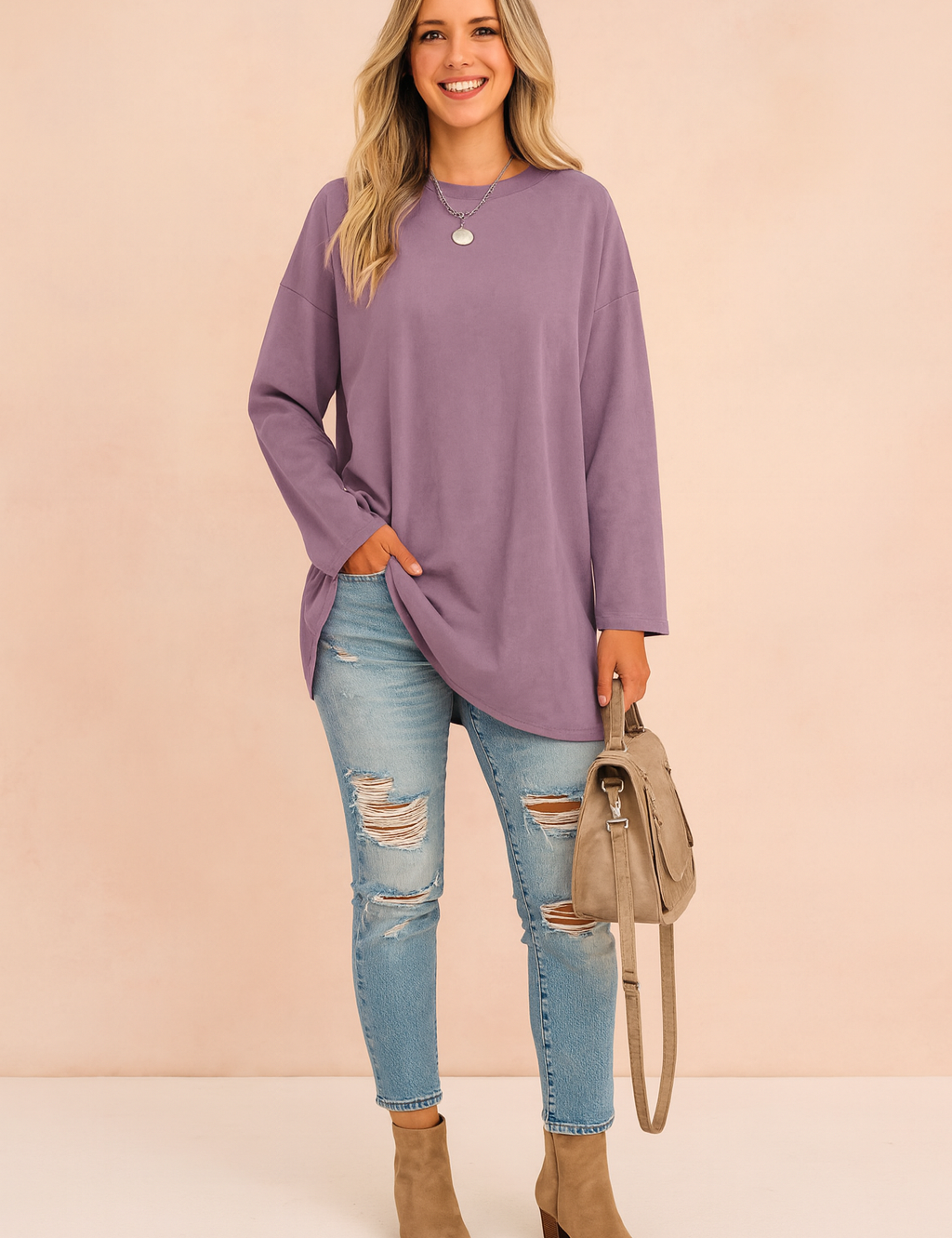 Oversized lavender long-sleeve tunic paired with light blue distressed skinny jeans, taupe ankle boots, and a matching taupe handbag.