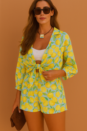 Vibrant two-piece lemon-print co-ord set with a front-tie button-up top and high-waisted shorts, worn over a white bandeau top.